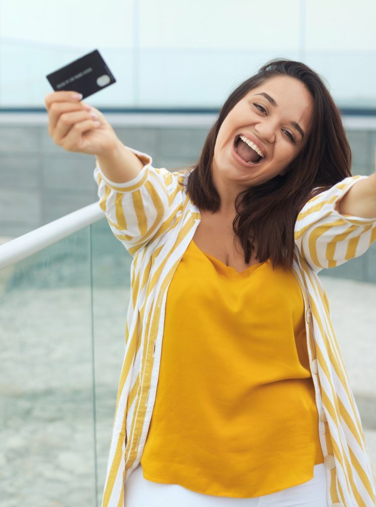 happy-woman-made-a-payment-with-a-bank-card-online-through-an-application-in-a-mobile-phone.jpg